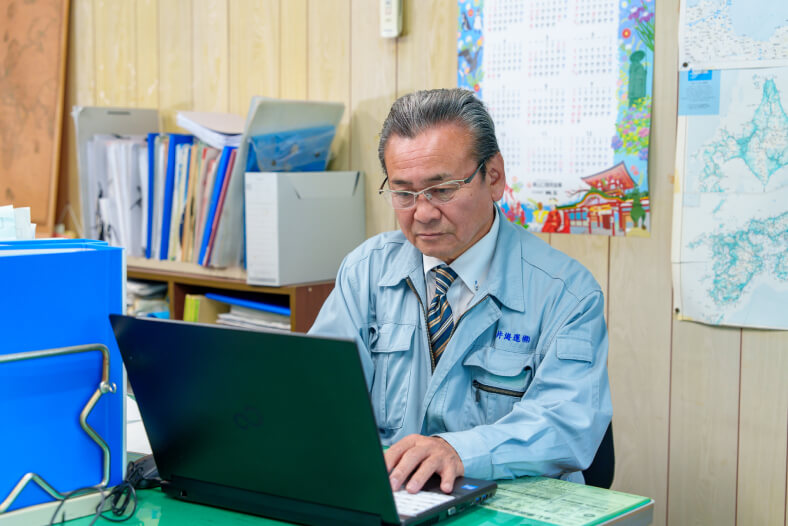 柳井海運株式会社のオフィスでパソコン作業をする社員の写真