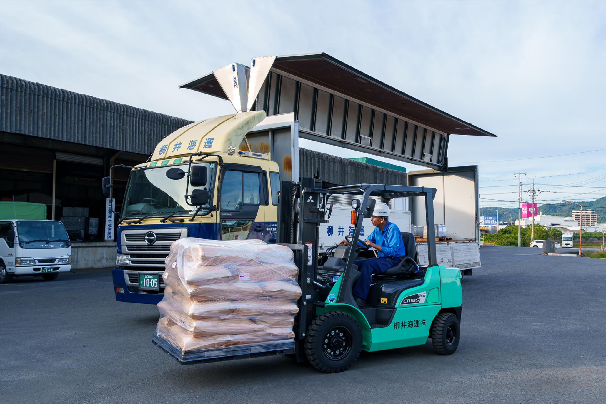 従業員がフォークリフトを操作している写真。採用案内を表現。